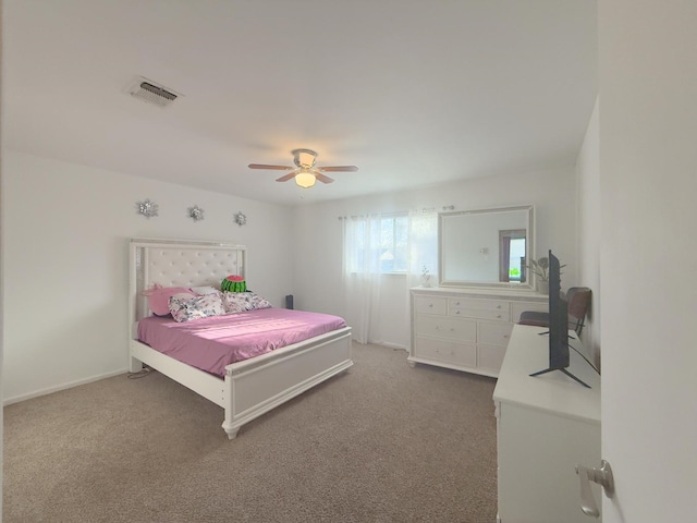 carpeted bedroom featuring baseboards, visible vents, and ceiling fan