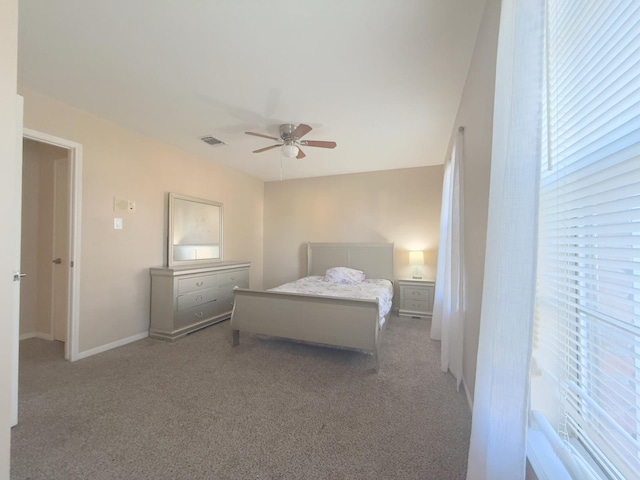 bedroom featuring visible vents, baseboards, a ceiling fan, and carpet floors