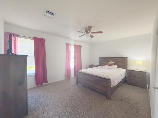 bedroom with visible vents, a ceiling fan, and carpet