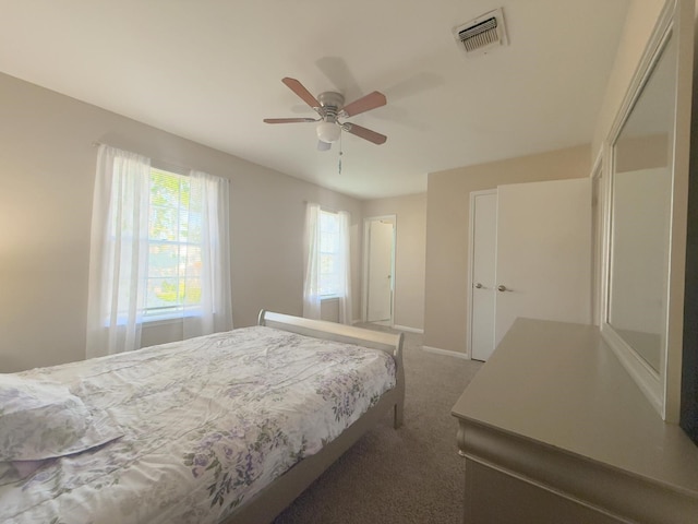 bedroom with visible vents, baseboards, a ceiling fan, and carpet floors