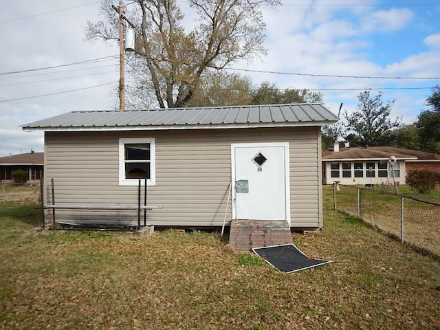 view of outbuilding with fence and an outdoor structure