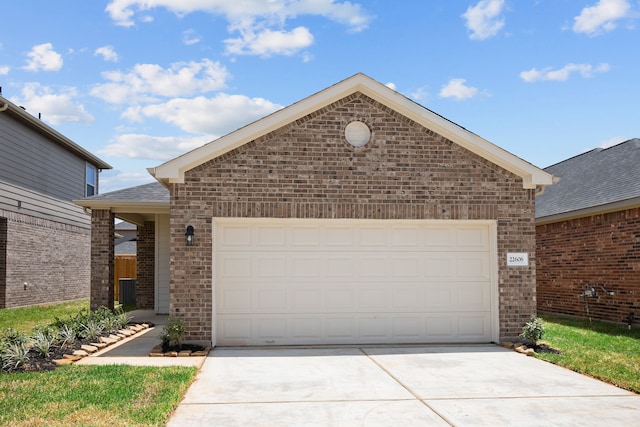 single story home with a garage, concrete driveway, brick siding, and a shingled roof