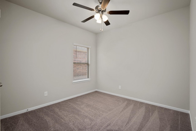 carpeted empty room featuring ceiling fan and baseboards