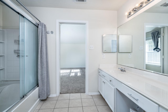 bathroom with enclosed tub / shower combo, vanity, visible vents, and tile patterned floors