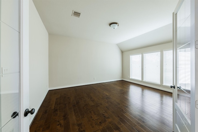 unfurnished room with french doors, vaulted ceiling, dark wood-style flooring, and visible vents