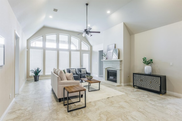 living room featuring visible vents, a glass covered fireplace, ceiling fan, and vaulted ceiling