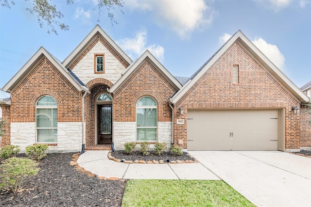 view of front facade featuring stone siding, concrete driveway, brick siding, and an attached garage