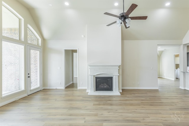4903 Cancun Hills Ct, Fulshear, TX 77441 - unfurnished living room featuring high vaulted ceiling, a ceiling fan, a glass covered fireplace, light wood-type flooring, and recessed lighting