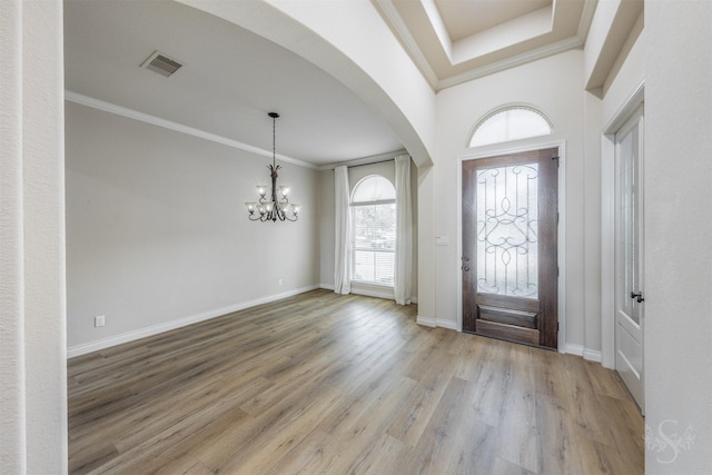 4903 Cancun Hills Ct, Fulshear, TX 77441 - entryway with arched walkways, a chandelier, crown molding, and wood finished floors