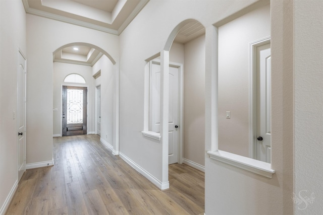 4903 Cancun Hills Ct, Fulshear, TX 77441 - entrance foyer featuring arched walkways, a raised ceiling, light wood finished floors, and ornamental molding