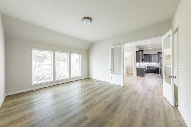 4903 Cancun Hills Ct, Fulshear, TX 77441 - empty room with french doors, light wood finished floors, and lofted ceiling