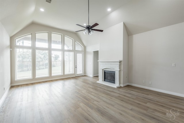 4903 Cancun Hills Ct, Fulshear, TX 77441 - unfurnished living room featuring vaulted ceiling, ceiling fan, light wood-type flooring, a glass covered fireplace, and recessed lighting