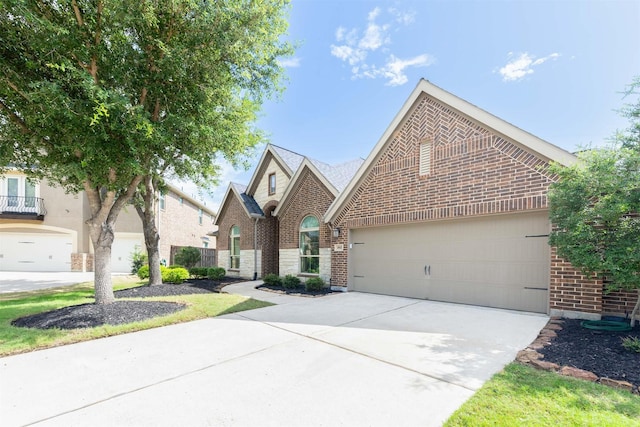 4903 Cancun Hills Ct, Fulshear, TX 77441 - view of front of house featuring brick siding, concrete driveway, and an attached garage