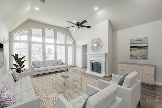 4903 Cancun Hills Ct, Fulshear, TX 77441 - living area with lofted ceiling, a ceiling fan, a glass covered fireplace, wood finished floors, and recessed lighting