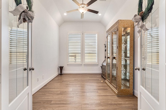 interior space featuring vaulted ceiling, french doors, wood finished floors, and a ceiling fan