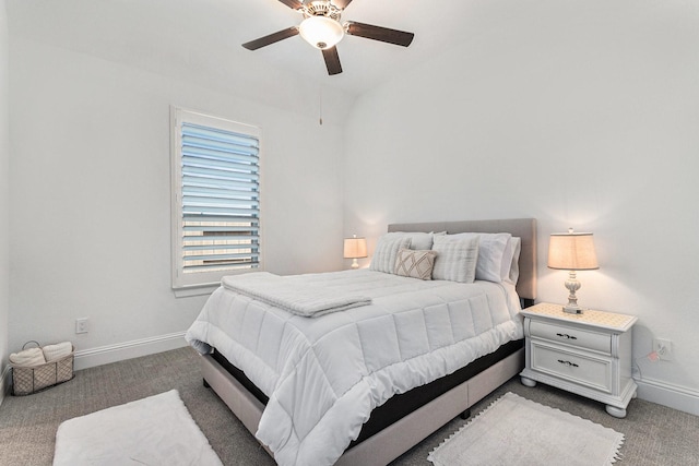 carpeted bedroom with ceiling fan and baseboards