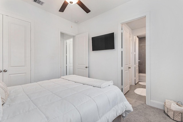 carpeted bedroom featuring visible vents, ceiling fan, and ensuite bathroom