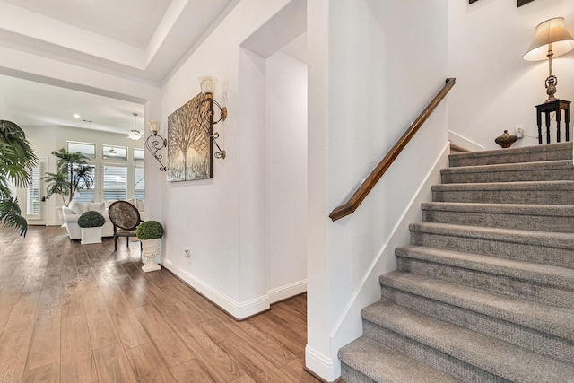 stairway with baseboards and wood finished floors