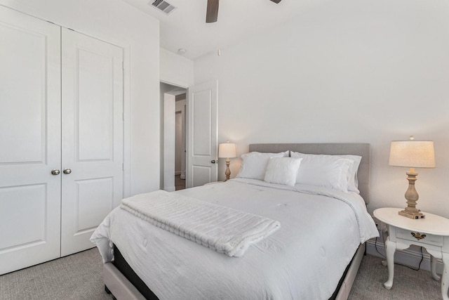 carpeted bedroom with ceiling fan, a closet, and visible vents