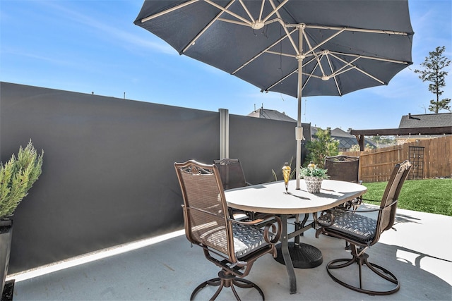 view of patio / terrace with outdoor dining space and fence