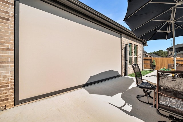 view of patio with outdoor dining space and fence