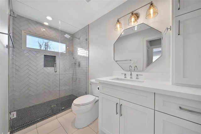 bathroom featuring tile patterned floors, a shower stall, toilet, and vanity