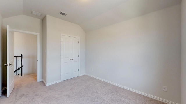 2011 Sunflower Ct, Sugar Land, TX 77498 - unfurnished bedroom with lofted ceiling, light colored carpet, baseboards, and a closet