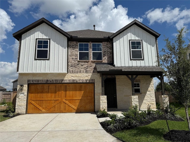 2011 Sunflower Ct, Sugar Land, TX 77498 - view of front of home featuring board and batten siding, a garage, roof with shingles, and stone siding