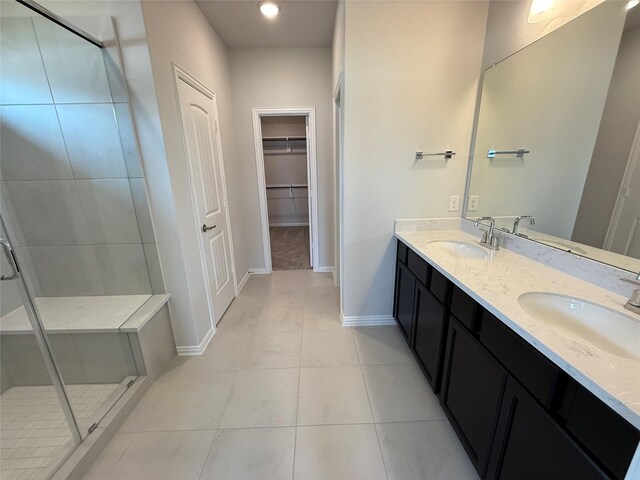 2011 Sunflower Ct, Sugar Land, TX 77498 - bathroom with double vanity, a shower stall, a spacious closet, tile patterned flooring, and recessed lighting