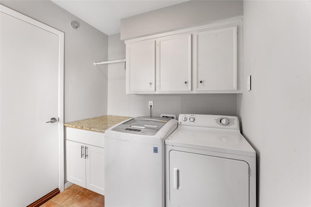 laundry area with cabinet space and separate washer and dryer