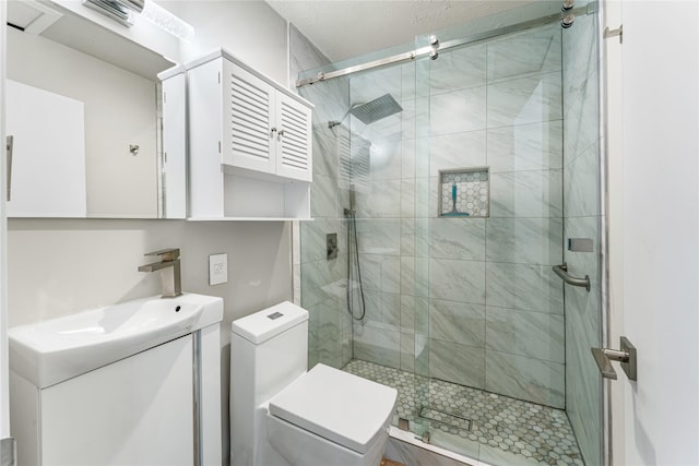 full bathroom featuring toilet, a stall shower, and vanity