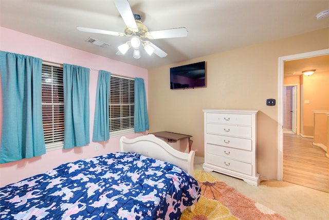 bedroom featuring carpet floors, visible vents, and a ceiling fan