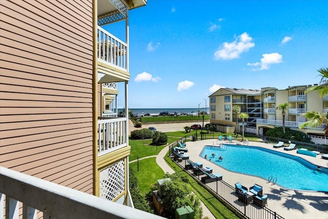 community pool featuring fence and a patio