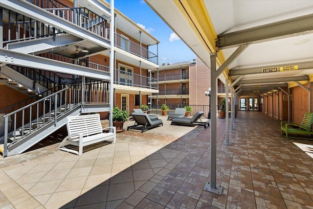 surrounding community featuring stairway and a patio area