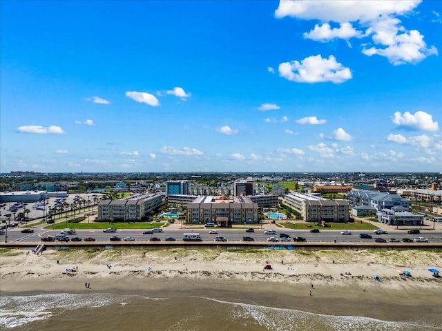 aerial view with a water view, a view of city, and a beach view