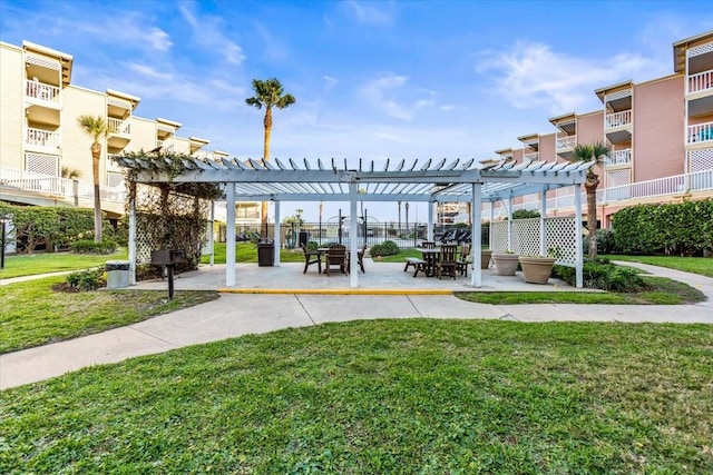 view of property's community with a patio area, a pergola, and a lawn