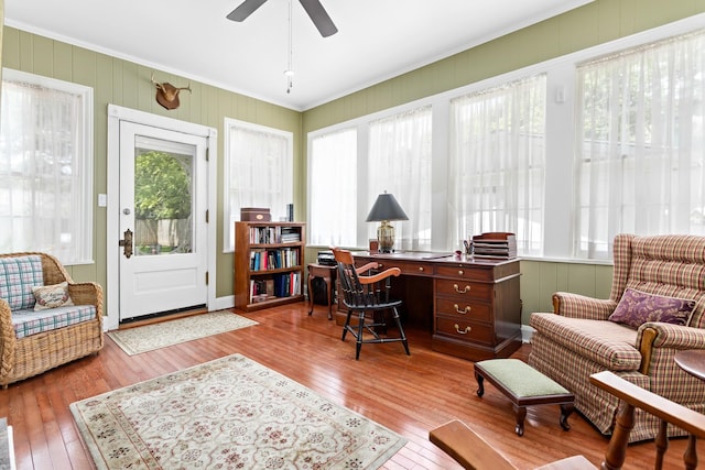 home office featuring a ceiling fan, ornamental molding, and hardwood / wood-style floors