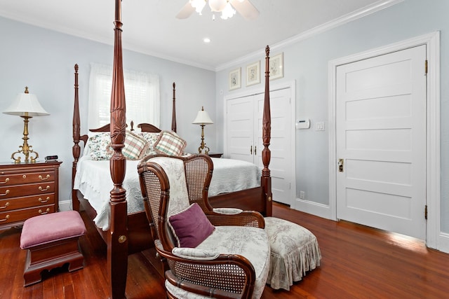 bedroom with ornamental molding, wood finished floors, a ceiling fan, and baseboards