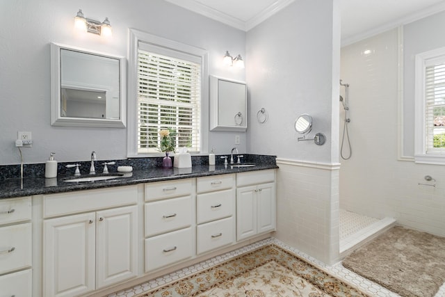 bathroom featuring ornamental molding, walk in shower, a sink, and tile patterned floors