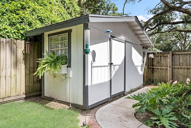 view of shed featuring fence