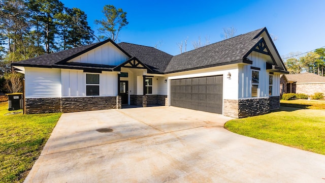 modern farmhouse featuring driveway, a front lawn, stone siding, board and batten siding, and a garage