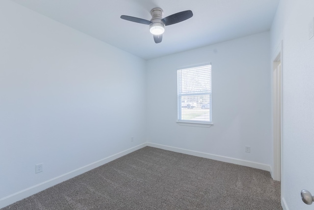 unfurnished room with baseboards, dark carpet, and ceiling fan