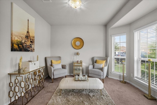 sitting room featuring carpet flooring and baseboards