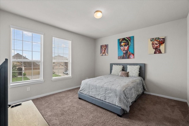 carpeted bedroom featuring baseboards