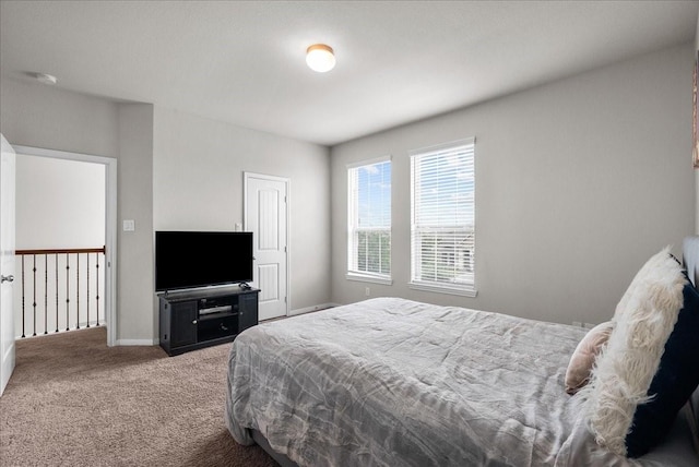 carpeted bedroom featuring baseboards