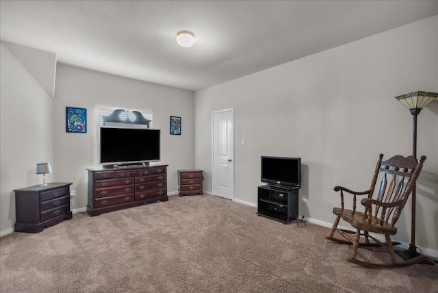 carpeted living area featuring baseboards