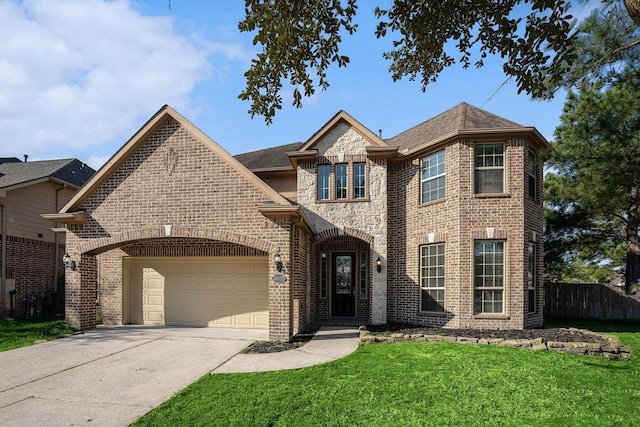 traditional home featuring brick siding, concrete driveway, an attached garage, a front yard, and fence