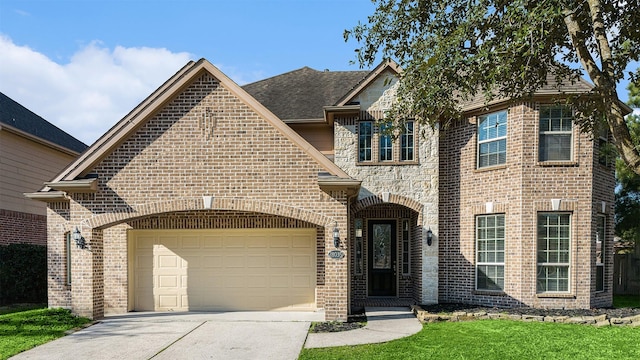 view of front of house with brick siding, roof with shingles, concrete driveway, a garage, and stone siding