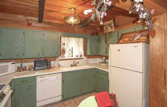 kitchen with white appliances, light tile patterned floors, light countertops, and a sink