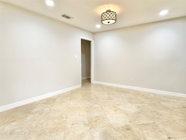 spare room with baseboards, visible vents, and recessed lighting